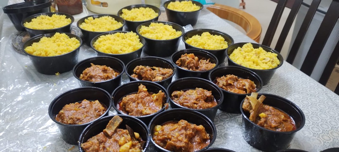 Mutton kosha and kaju-kismis pulao packed for a birthday, catered via Aayojan